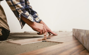 Home improvement, handyman placing tile spacer