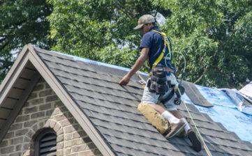 Belmont, North Carolina, USA - June 23, 2018: Roofing contractors replace roofs on residents’ homes in Belmont, North Carolina after a hail storm moved through the area on April 15, 2018. Golfball-sized hail was wide-spread and caused much property damage–especially to roofs. Roofing contractors are working seven days a week in temperatures over 90 degrees to meet demand from homeowners. Even at this rate, it could take several years to replace all of the roofs which received damage from the storm.